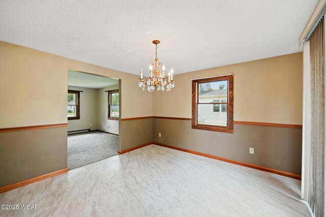 514 S Wayne St, Van Wert, OH 45891 - empty room featuring a chandelier, baseboards, a baseboard radiator, and marble look tiles