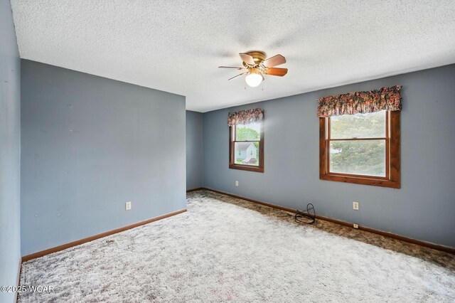 514 S Wayne St, Van Wert, OH 45891 - carpeted spare room featuring ceiling fan, baseboards, and a textured ceiling