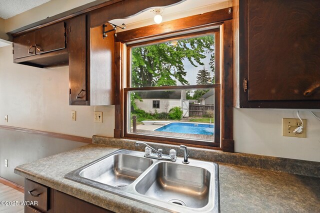 514 S Wayne St, Van Wert, OH 45891 - kitchen with a sink and dark brown cabinetry