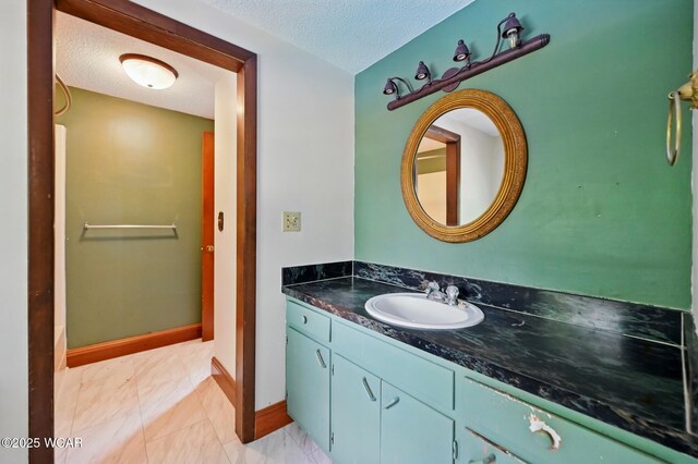 514 S Wayne St, Van Wert, OH 45891 - bathroom featuring a textured ceiling, vanity, and baseboards