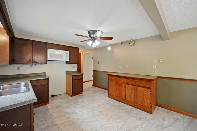 514 S Wayne St, Van Wert, OH 45891 - kitchen featuring white microwave, a sink, a ceiling fan, a textured ceiling, and baseboards