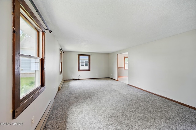 514 S Wayne St, Van Wert, OH 45891 - spare room featuring light carpet, a textured ceiling, baseboards, and a baseboard radiator