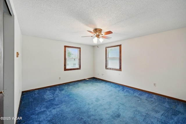 514 S Wayne St, Van Wert, OH 45891 - unfurnished room with ceiling fan, dark carpet, baseboards, and a textured ceiling