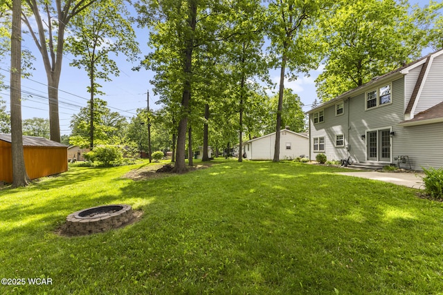 120 Barnsbury Dr, Lima, OH 45804 - view of green lawn with an outdoor fire pit and a patio area