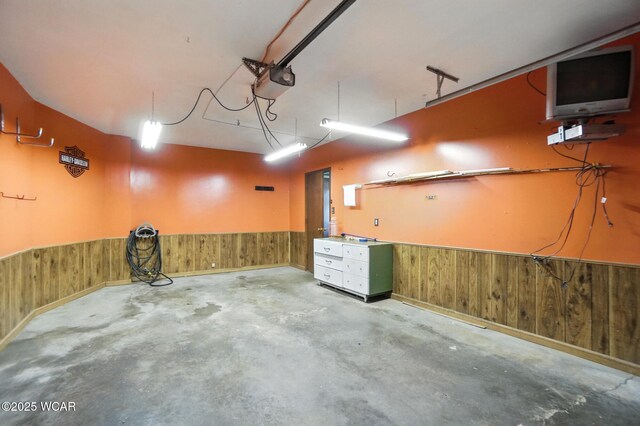 591 Monticello Ave Unit A, Lima, OH 45804 - garage featuring a wainscoted wall, a garage door opener, and wood walls
