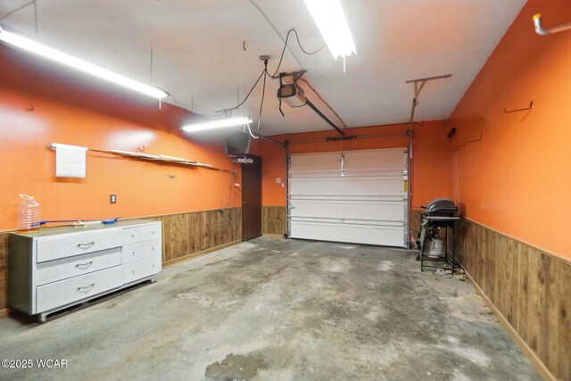591 Monticello Ave Unit A, Lima, OH 45804 - garage featuring wood walls, a wainscoted wall, and a garage door opener