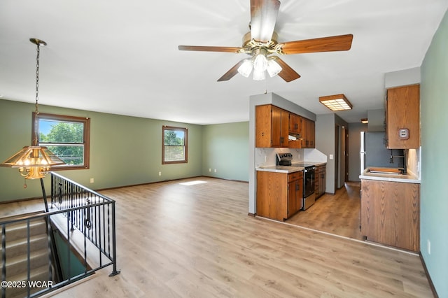 591 Monticello Ave Unit A, Lima, OH 45804 - kitchen with stainless steel electric range oven, brown cabinets, light countertops, and healthy amount of natural light