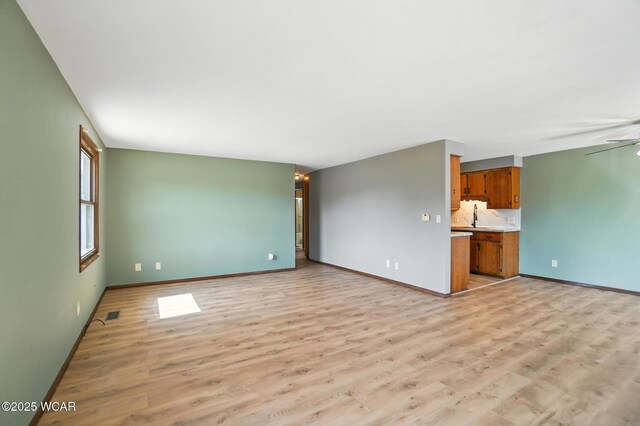 591 Monticello Ave Unit A, Lima, OH 45804 - unfurnished living room with light wood-style floors and ceiling fan