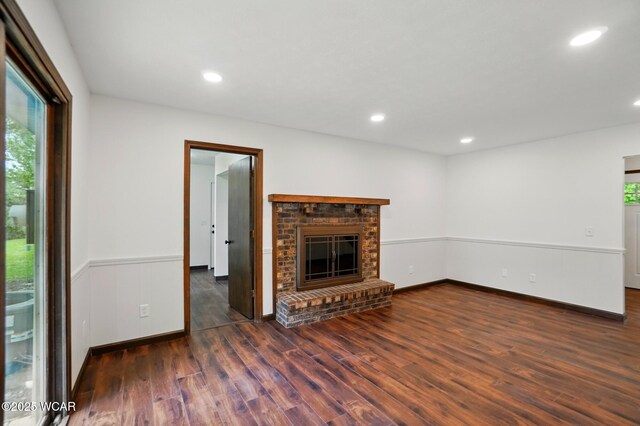 1257 Timberlane Dr, Lima, OH 45805 - unfurnished living room featuring healthy amount of natural light, wood finished floors, a brick fireplace, recessed lighting, and baseboards