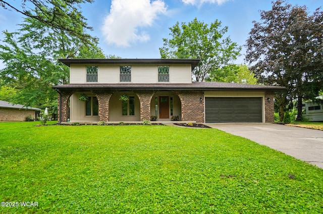 1257 Timberlane Dr, Lima, OH 45805 - traditional home featuring covered porch, concrete driveway, a garage, and a front yard