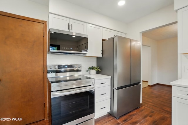 1257 Timberlane Dr, Lima, OH 45805 - kitchen with appliances with stainless steel finishes, light countertops, dark wood-type flooring, white cabinets, and baseboards