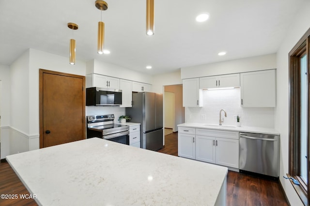 1257 Timberlane Dr, Lima, OH 45805 - kitchen featuring stainless steel appliances, a sink, white cabinetry, backsplash, and dark wood-style floors