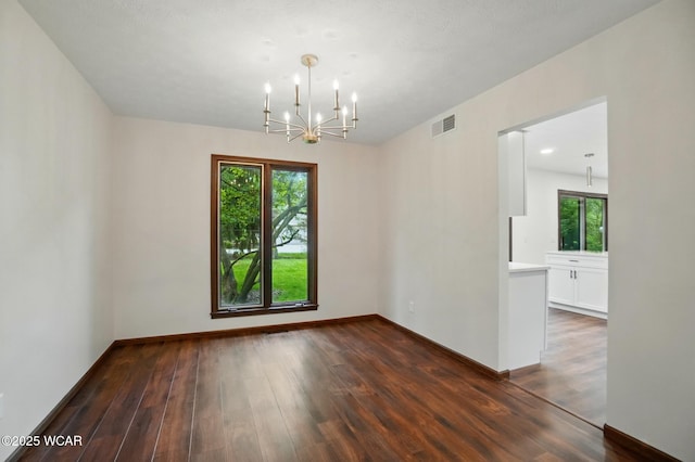 1257 Timberlane Dr, Lima, OH 45805 - unfurnished room featuring a chandelier, dark wood-style floors, and baseboards