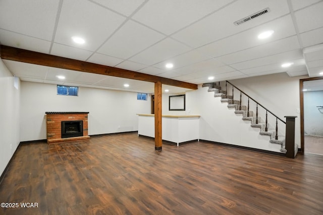 1257 Timberlane Dr, Lima, OH 45805 - finished basement featuring dark wood-type flooring, baseboards, stairs, a fireplace, and recessed lighting