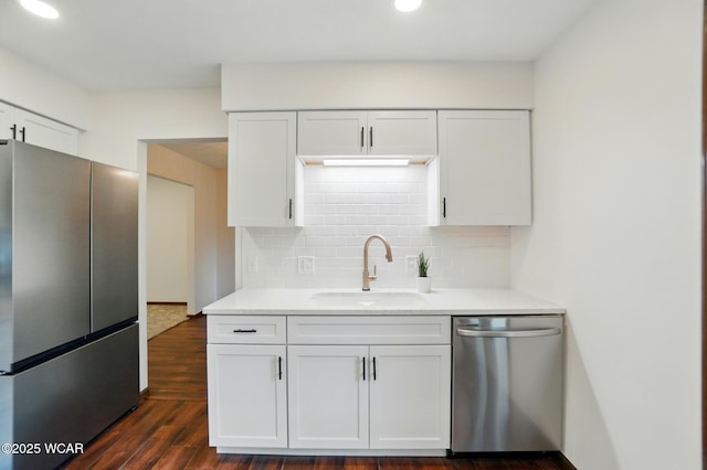 1257 Timberlane Dr, Lima, OH 45805 - kitchen featuring appliances with stainless steel finishes, backsplash, white cabinetry, a sink, and light countertops