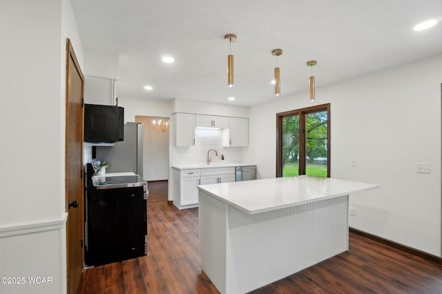 1257 Timberlane Dr, Lima, OH 45805 - kitchen with stainless steel appliances, a sink, white cabinets, light countertops, and dark wood finished floors