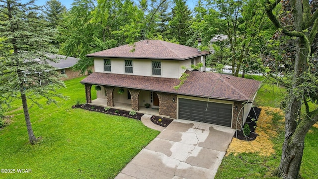 1257 Timberlane Dr, Lima, OH 45805 - view of front facade featuring covered porch, roof with shingles, driveway, a front lawn, and brick siding