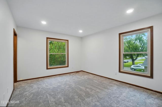 1257 Timberlane Dr, Lima, OH 45805 - spare room with healthy amount of natural light, carpet floors, recessed lighting, and baseboards