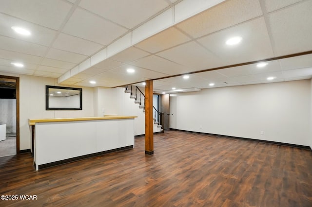 1257 Timberlane Dr, Lima, OH 45805 - finished basement featuring dark wood finished floors, stairway, recessed lighting, baseboards, and a drop ceiling