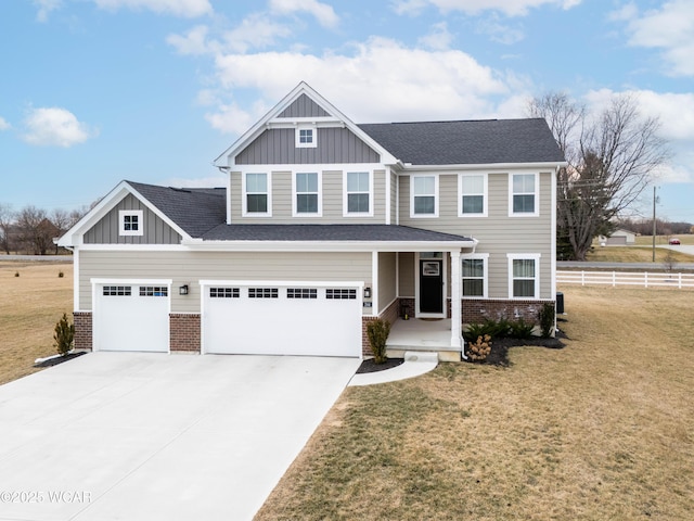 craftsman-style home featuring driveway, brick siding, fence, board and batten siding, and a front yard