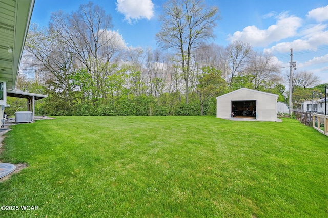 5712 Poling Rd, Elida, OH 45807 - view of green lawn featuring a detached garage, central AC unit, and an outbuilding