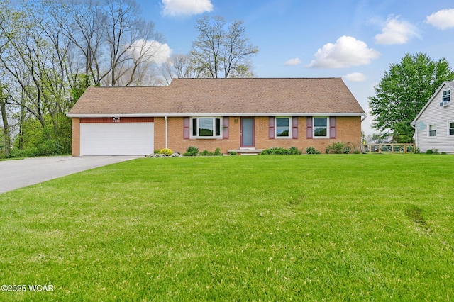 5712 Poling Rd, Elida, OH 45807 - view of front of house with a garage, driveway, brick siding, and a front lawn