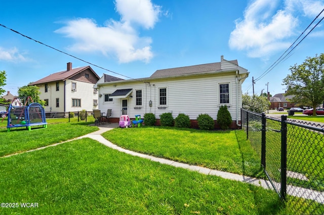 227 N Clay St, Delphos, OH 45833 - rear view of house with a trampoline, a patio area, and a chimney