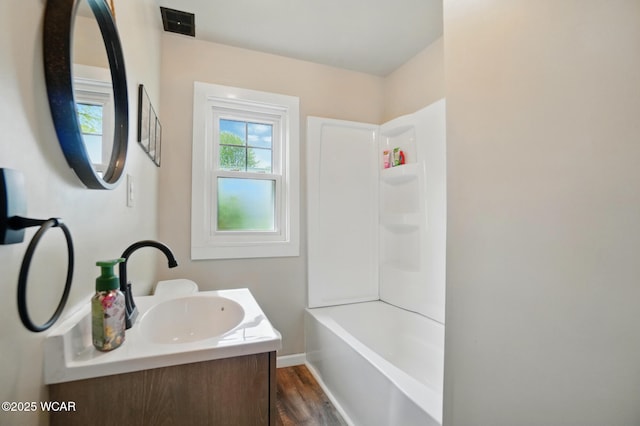 227 N Clay St, Delphos, OH 45833 - full bathroom featuring wood finished floors, vanity, shower / washtub combination, and baseboards