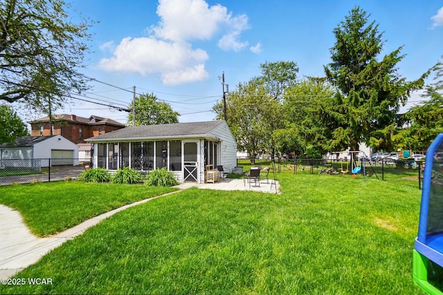 227 N Clay St, Delphos, OH 45833 - view of yard featuring a sunroom, a detached garage, a patio, and a playground