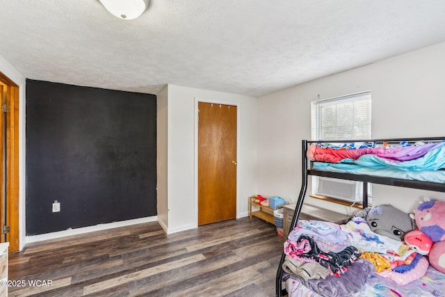 514 W Taylor St, Mount Victory, OH 43340 - bedroom featuring wood finished floors, a textured ceiling, and cooling unit