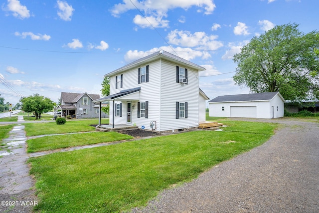 514 W Taylor St, Mount Victory, OH 43340 - view of front of property with a detached garage, an outdoor structure, a front lawn, and driveway