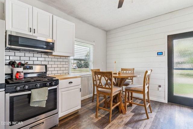 514 W Taylor St, Mount Victory, OH 43340 - kitchen with appliances with stainless steel finishes, tasteful backsplash, dark wood-style flooring, white cabinets, and wood counters