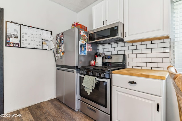 514 W Taylor St, Mount Victory, OH 43340 - kitchen featuring appliances with stainless steel finishes, dark wood-type flooring, wood counters, white cabinetry, and decorative backsplash
