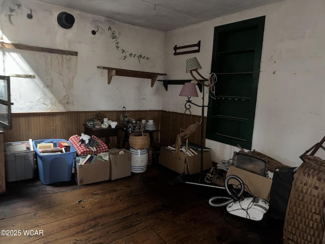 interior space featuring a wainscoted wall, wooden walls, and hardwood / wood-style flooring