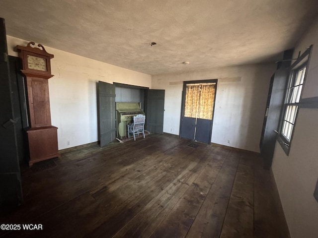 unfurnished living room with wood-type flooring