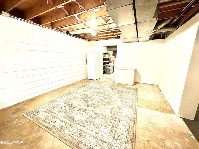 basement with white refrigerator