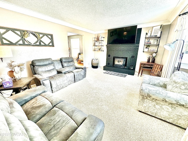 living room with a brick fireplace, carpet, and a textured ceiling