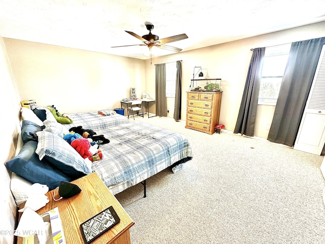 carpeted bedroom with ceiling fan