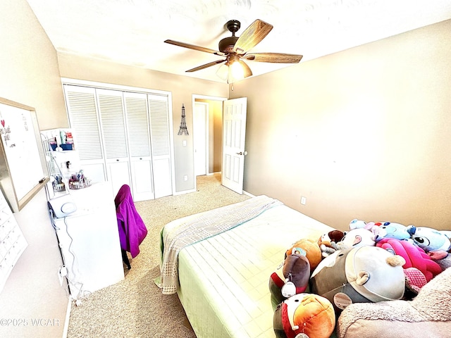 bedroom with ceiling fan, light colored carpet, and a closet