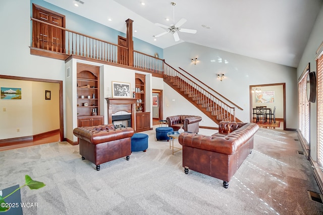 living room with light colored carpet, high vaulted ceiling, and ceiling fan