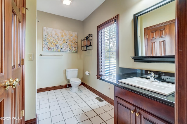 bathroom with vanity, tile patterned floors, and toilet