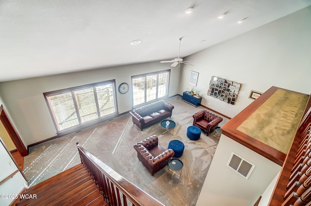 living room with lofted ceiling, carpet floors, and ceiling fan