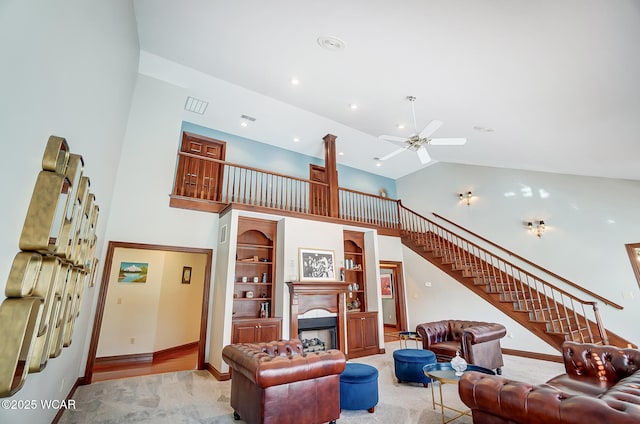 carpeted living room featuring ceiling fan and high vaulted ceiling