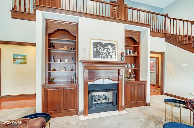 carpeted living room with built in shelves