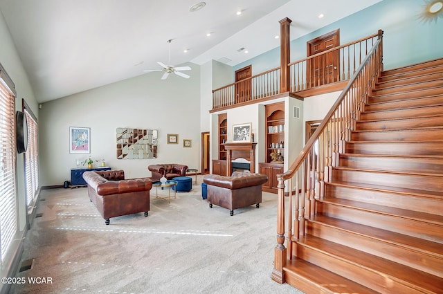 living room with high vaulted ceiling, ceiling fan, and carpet flooring