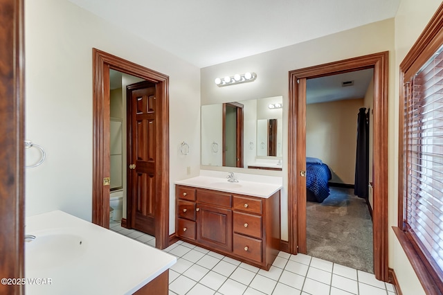 bathroom with vanity, toilet, and tile patterned flooring