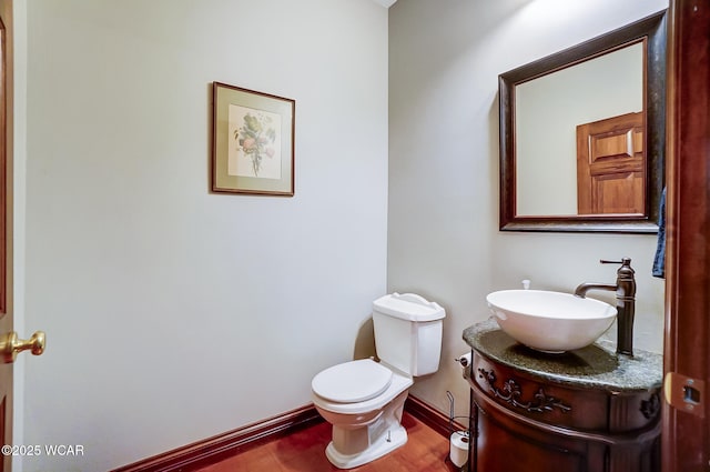 bathroom featuring hardwood / wood-style flooring, vanity, and toilet