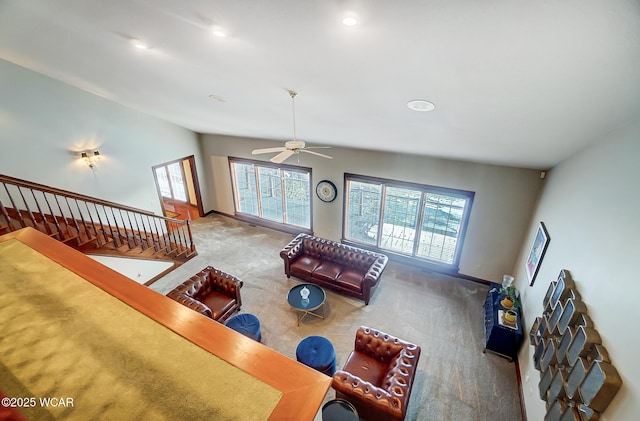 carpeted living room with ceiling fan