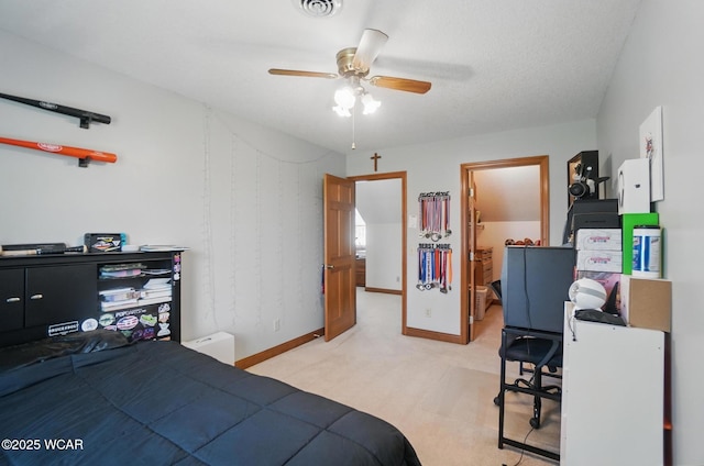 bedroom with baseboards, visible vents, light colored carpet, and ceiling fan