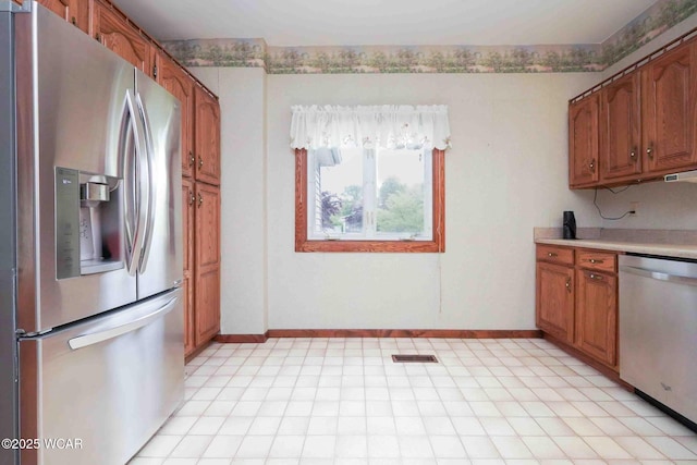 315 W Main St, Cairo, OH 45820 - kitchen with stainless steel appliances, brown cabinetry, light countertops, and baseboards